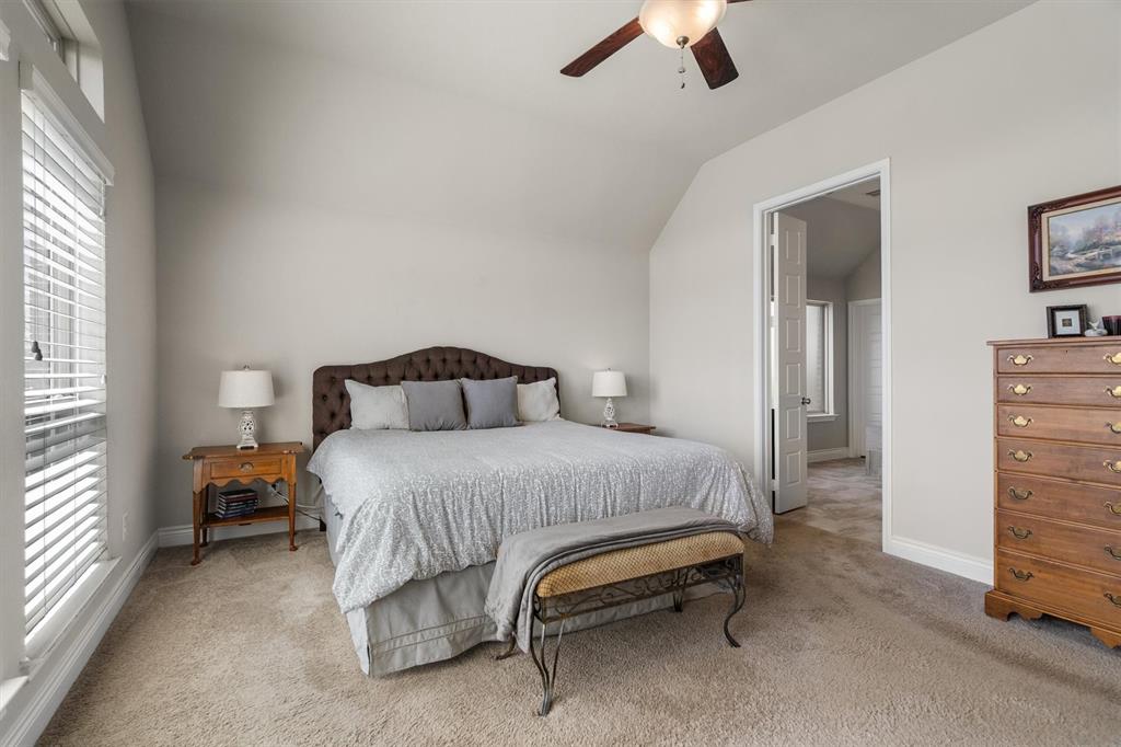 1647 Twistleaf Road Northlake, TX 76226 - Photo 20 of 39 a bedroom with a bed and a chandelier