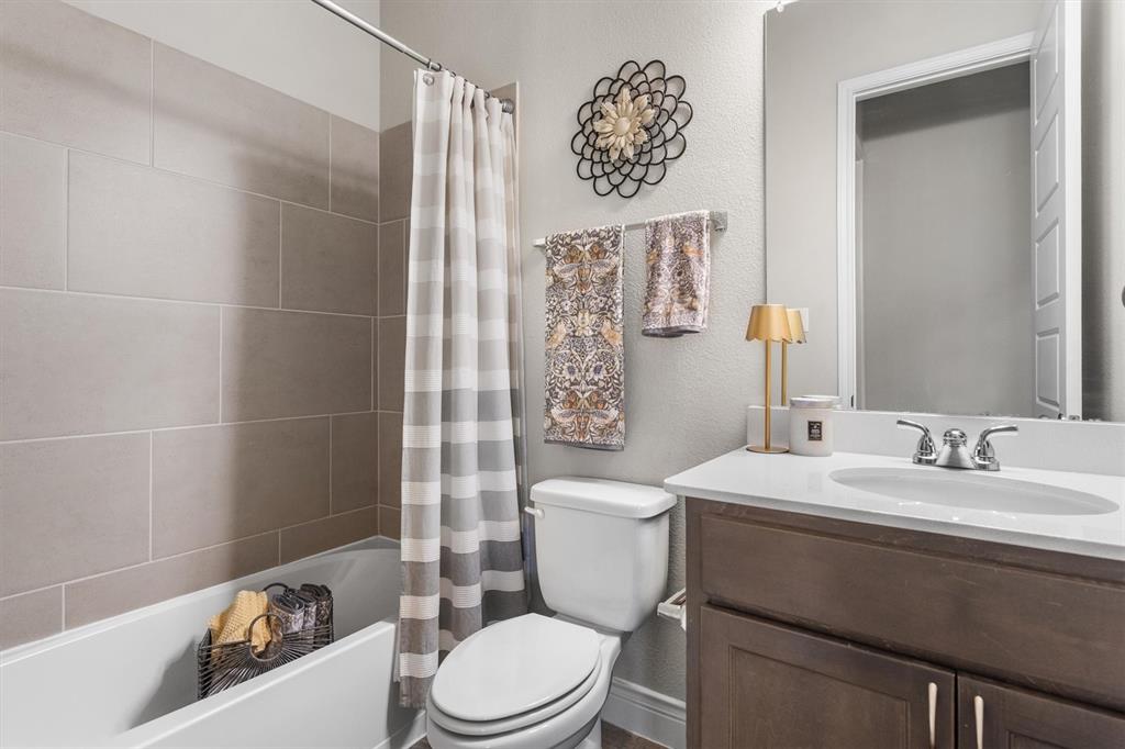 1647 Twistleaf Road Northlake, TX 76226 - Photo 25 of 39 a bathroom with a toilet a sink and shower