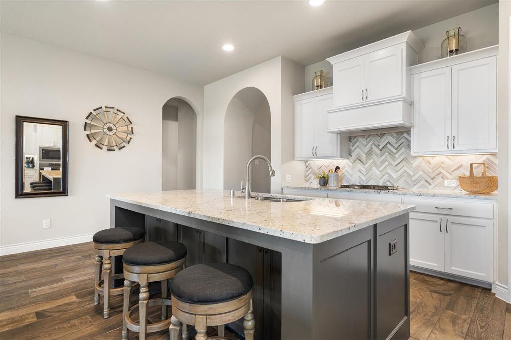 1647 Twistleaf Road Northlake, TX 76226 - Photo 10 of 39 a kitchen with a table chairs sink and cabinets