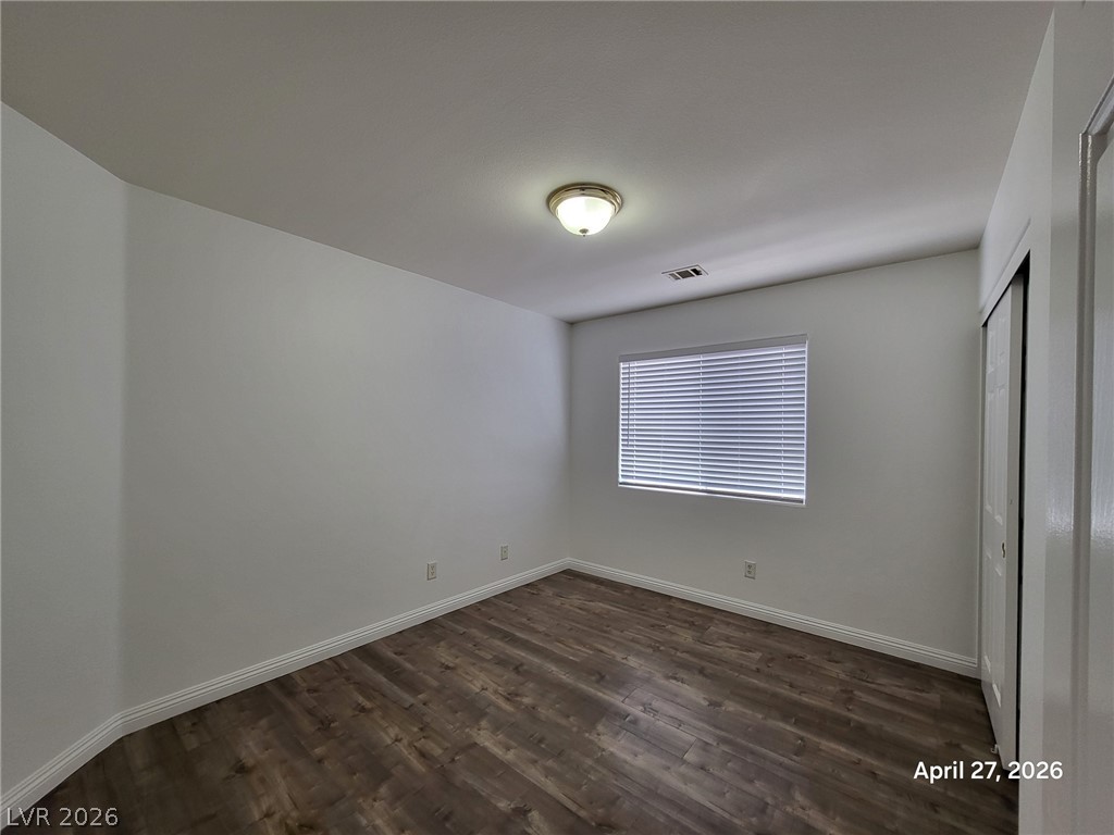 4548 Flaming Ridge Trail Las Vegas, NV 89147 - Photo 12 of 21 Gleaming wood-look floors pair with crisp white walls in this welcoming private retreat.