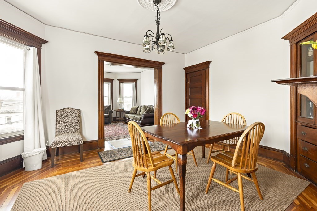55 Main Street Somerville, MA 02145 - Photo 10 of 28 a view of a dining room with furniture and a chandelier