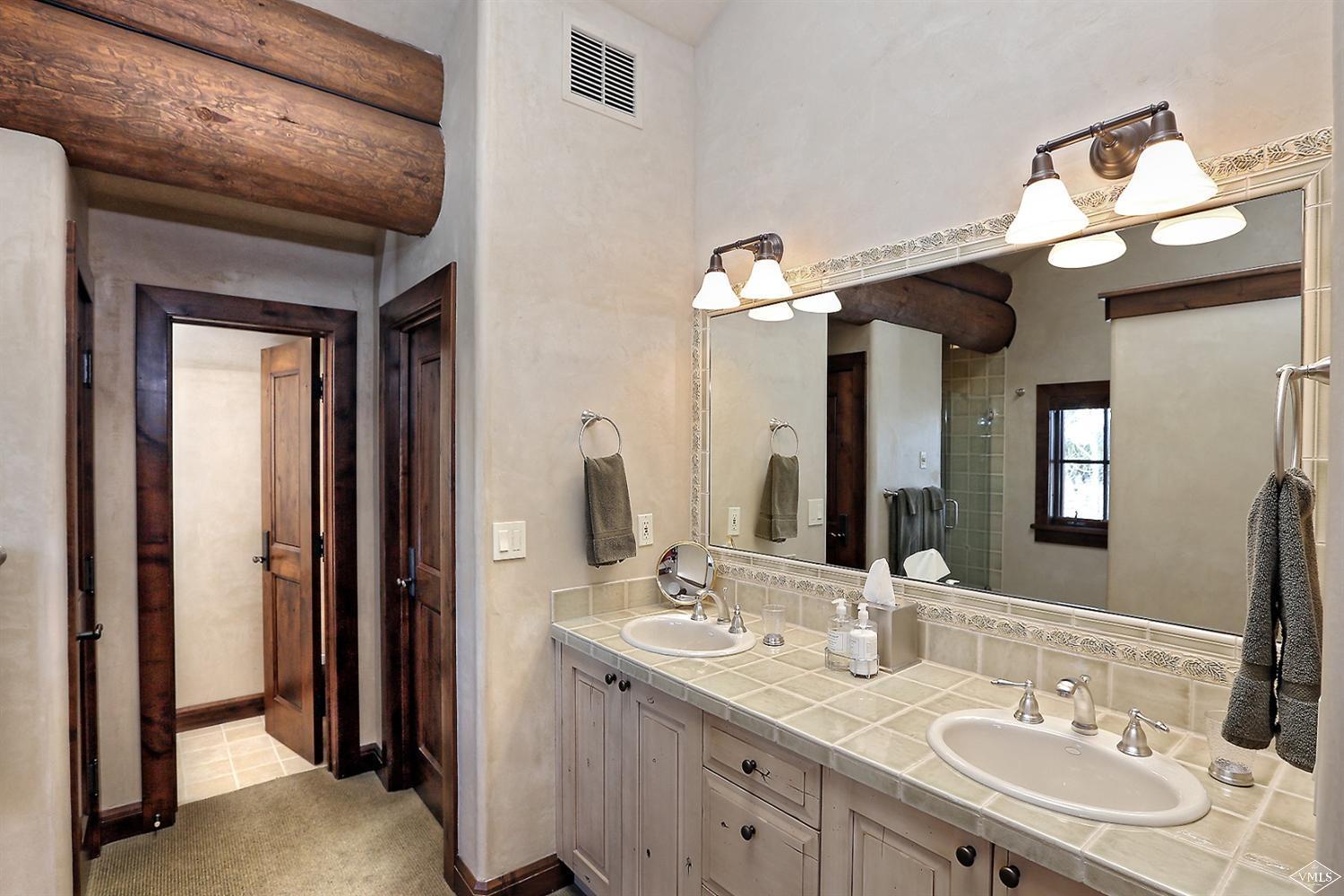 3508 Daybreak Ridge Road Avon, CO 81620 - Photo 15 of 25 a bathroom with a double vanity sink and a mirror