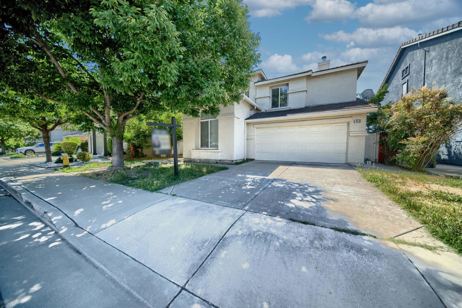 458 Burlington Drive Tracy, CA 95376 - Photo 1 of 1 a view of a white house with a yard and large tree