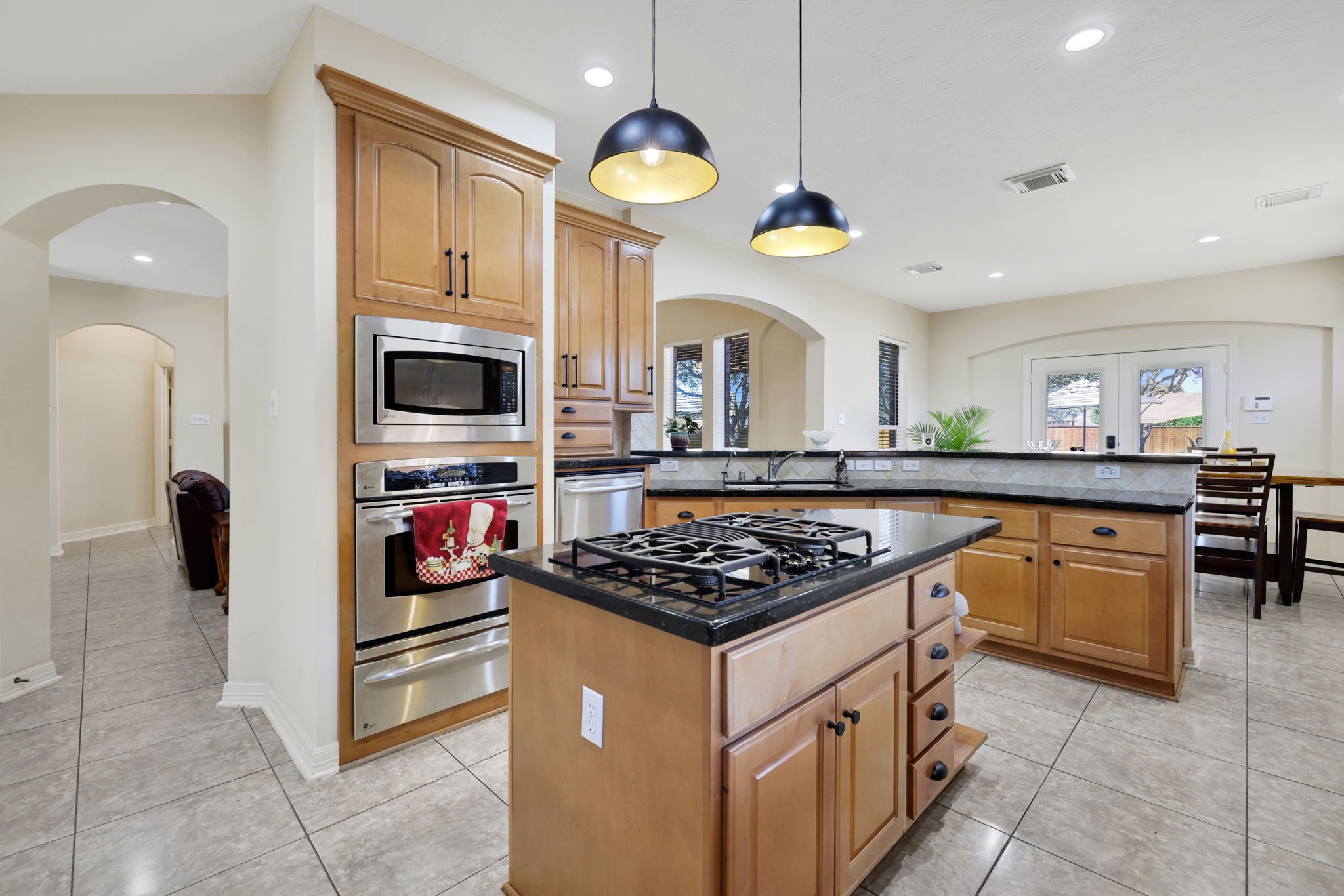 20810 East Cameron Ridge Drive Cypress, TX 77433 - Photo 13 of 48 a kitchen with stainless steel appliances kitchen island granite countertop a stove a sink and a microwave
