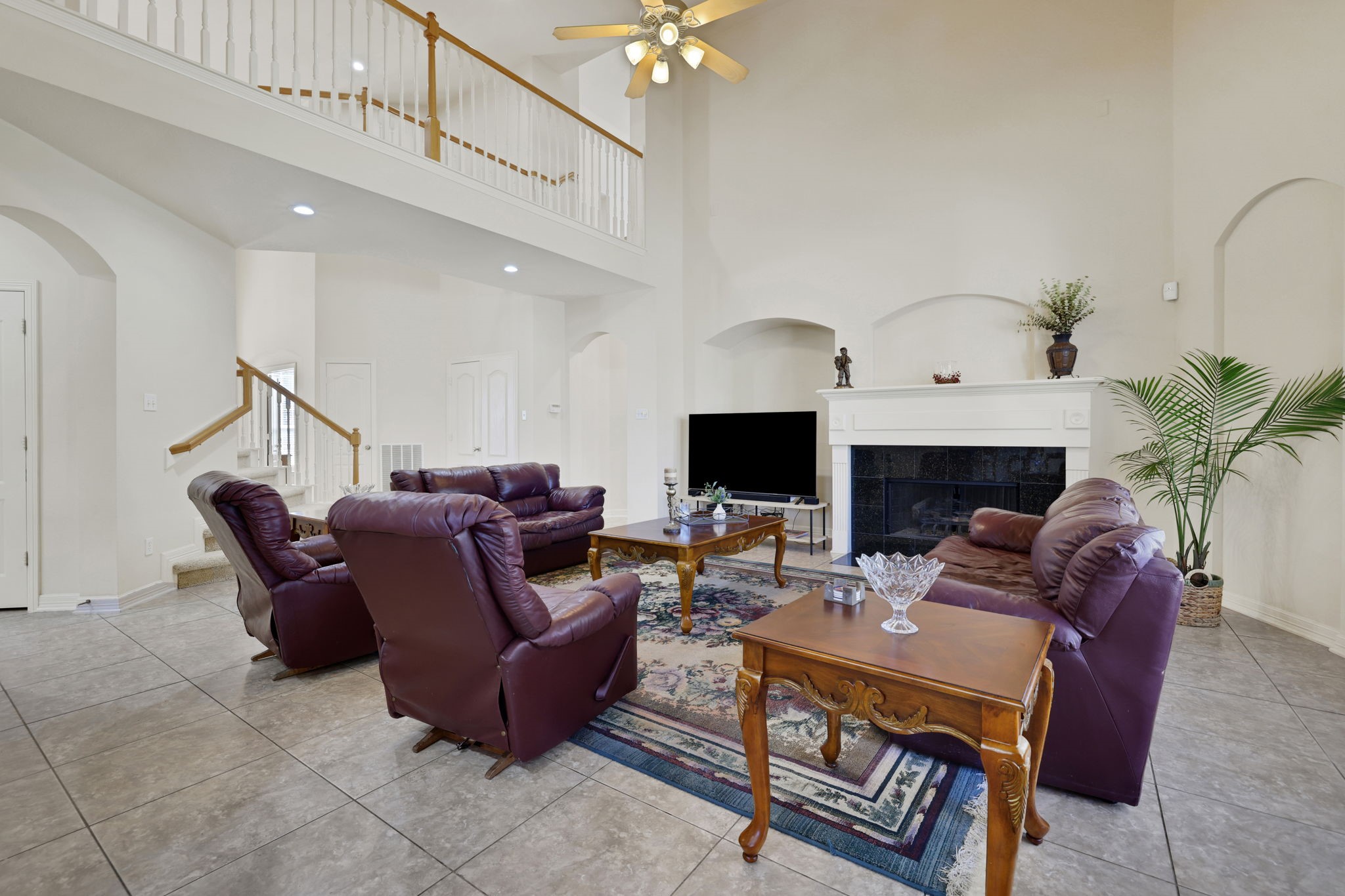 20810 East Cameron Ridge Drive Cypress, TX 77433 - Photo 16 of 48 a living room with furniture a fireplace and a flat screen tv
