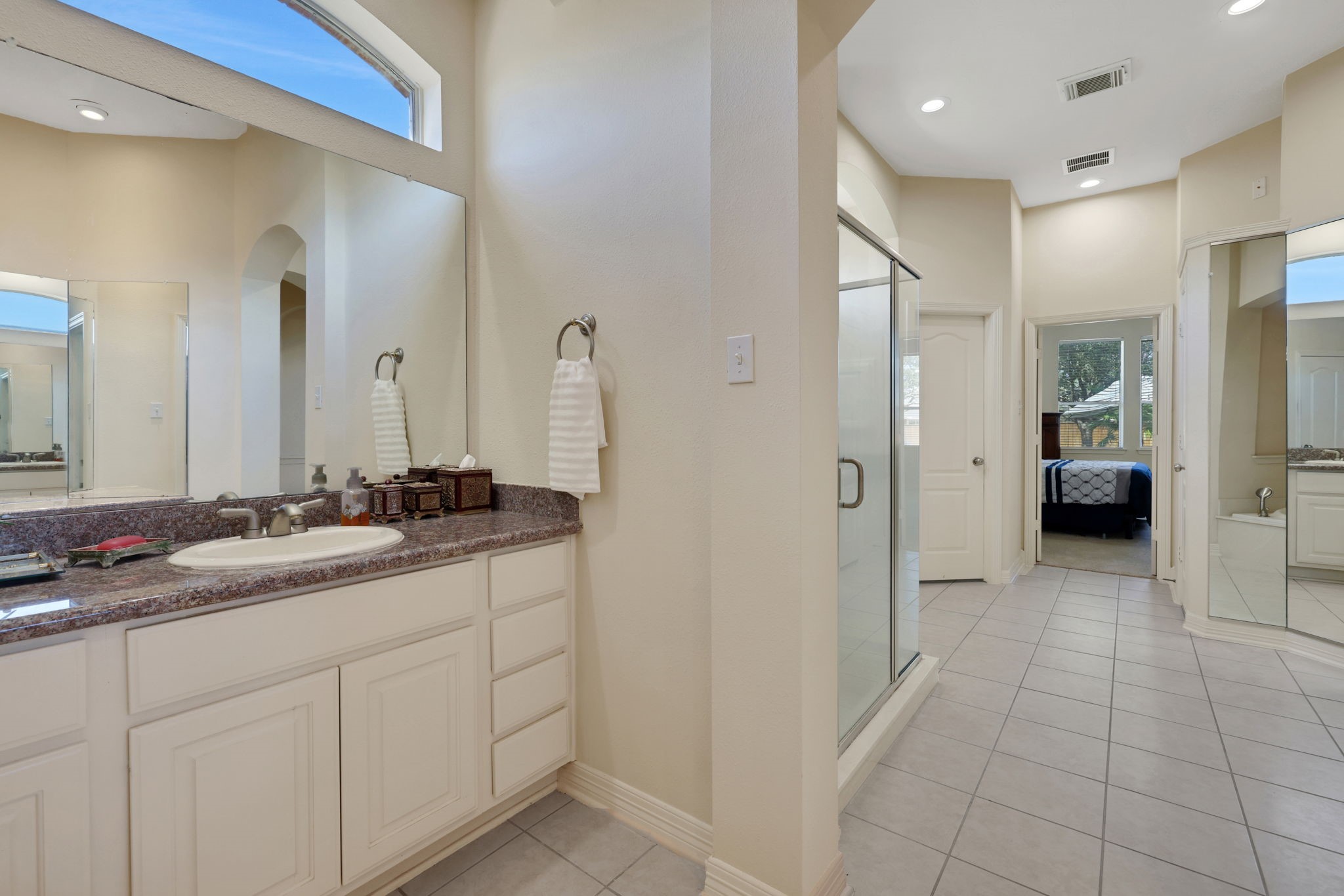 20810 East Cameron Ridge Drive Cypress, TX 77433 - Photo 19 of 48 a bathroom with a double vanity sink and mirror