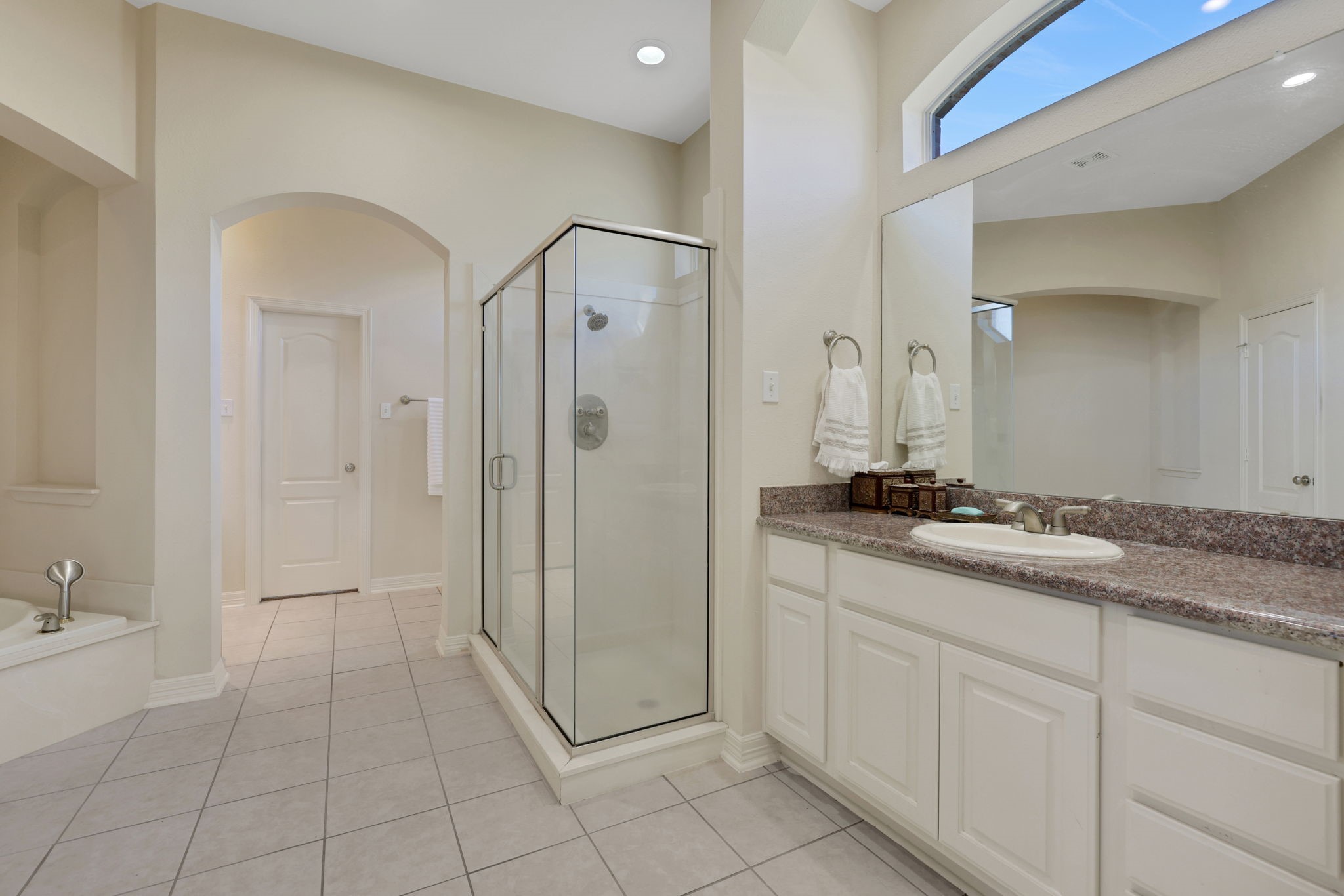 20810 East Cameron Ridge Drive Cypress, TX 77433 - Photo 21 of 48 a spacious bathroom with a granite countertop sink a mirror and a vanity