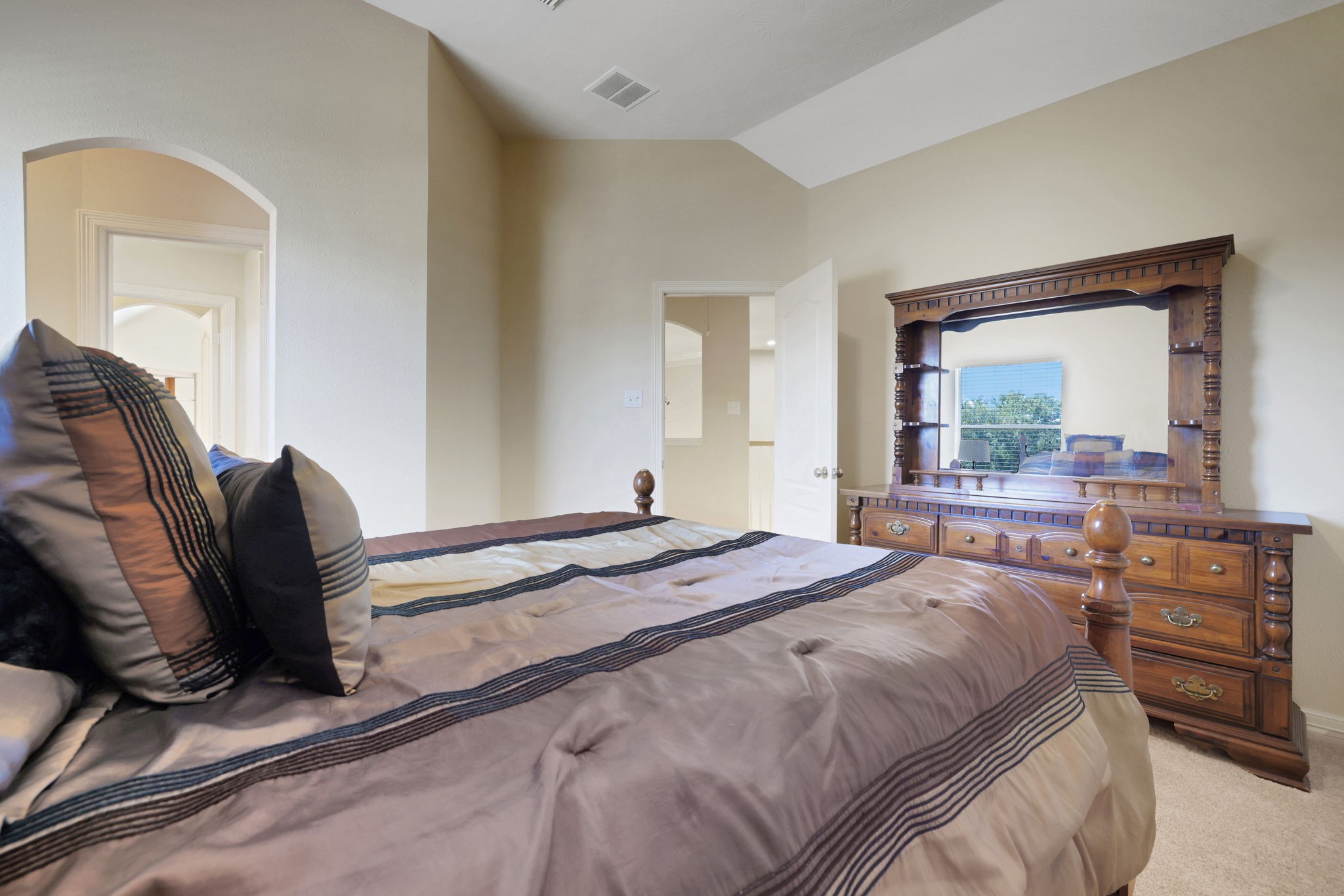 20810 East Cameron Ridge Drive Cypress, TX 77433 - Photo 26 of 48 a bedroom with a bed and dresser with mirror
