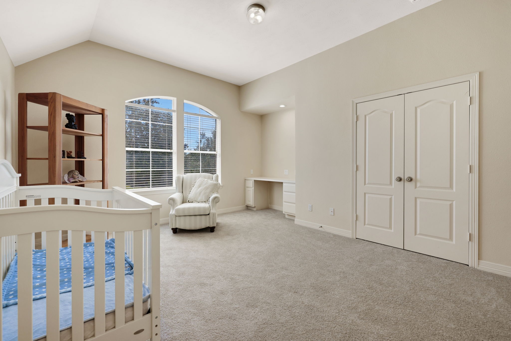 20810 East Cameron Ridge Drive Cypress, TX 77433 - Photo 30 of 48 a bedroom with a bed and a chandelier