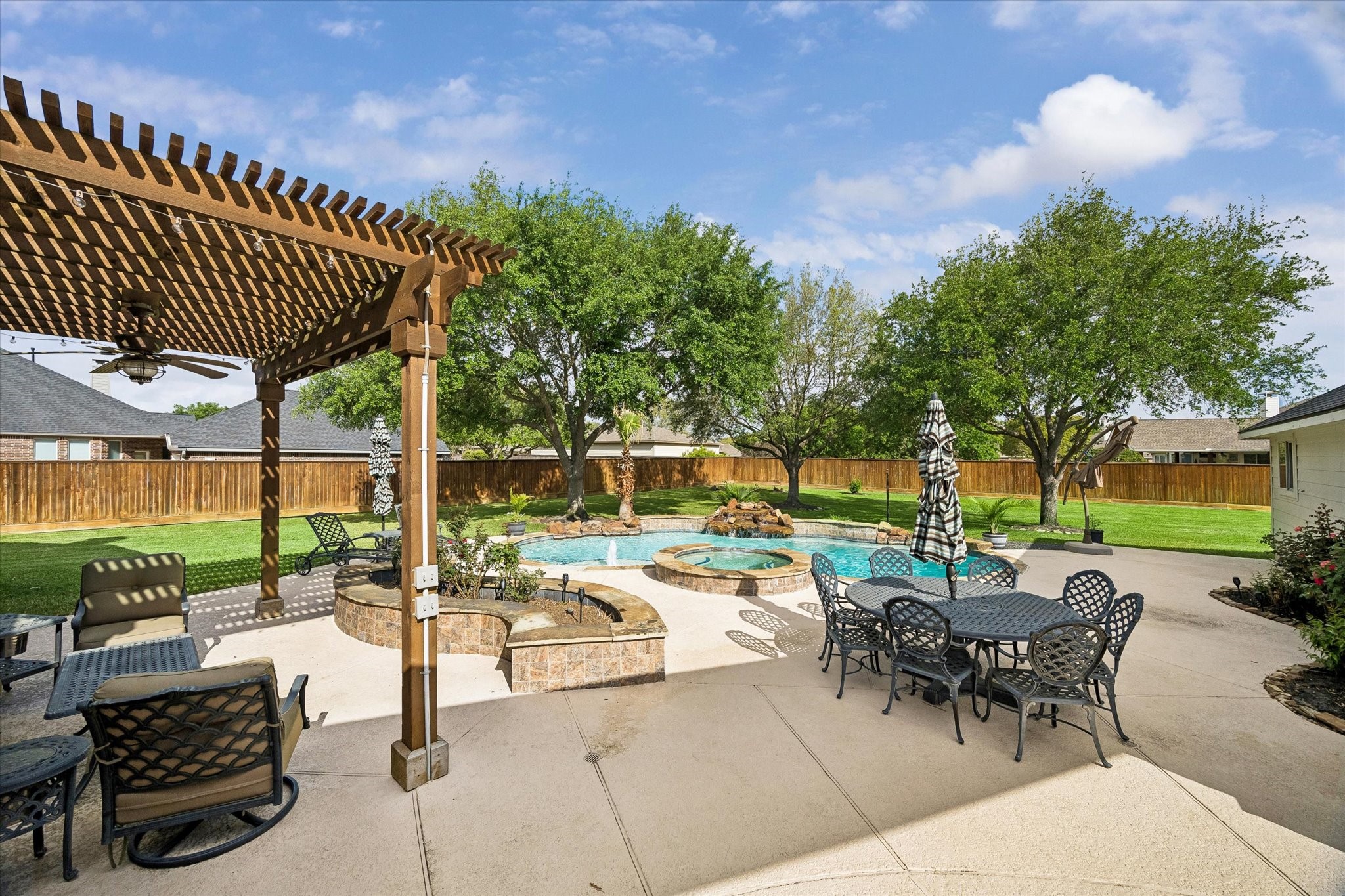 20810 East Cameron Ridge Drive Cypress, TX 77433 - Photo 36 of 48 a view of a patio with a dining table and chairs with a couches near a patio