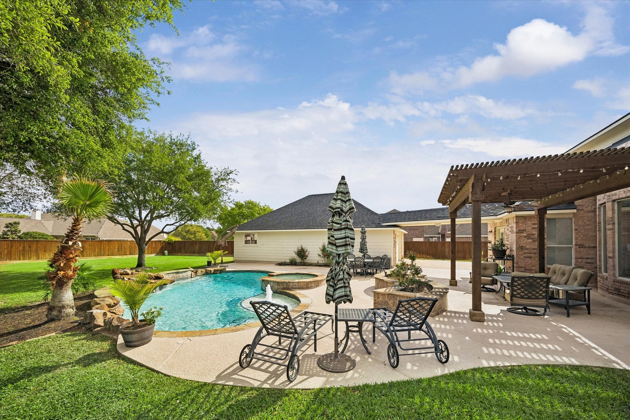 20810 East Cameron Ridge Drive Cypress, TX 77433 - Photo 5 of 48 a view of a patio with table and chairs and potted plants and big trees
