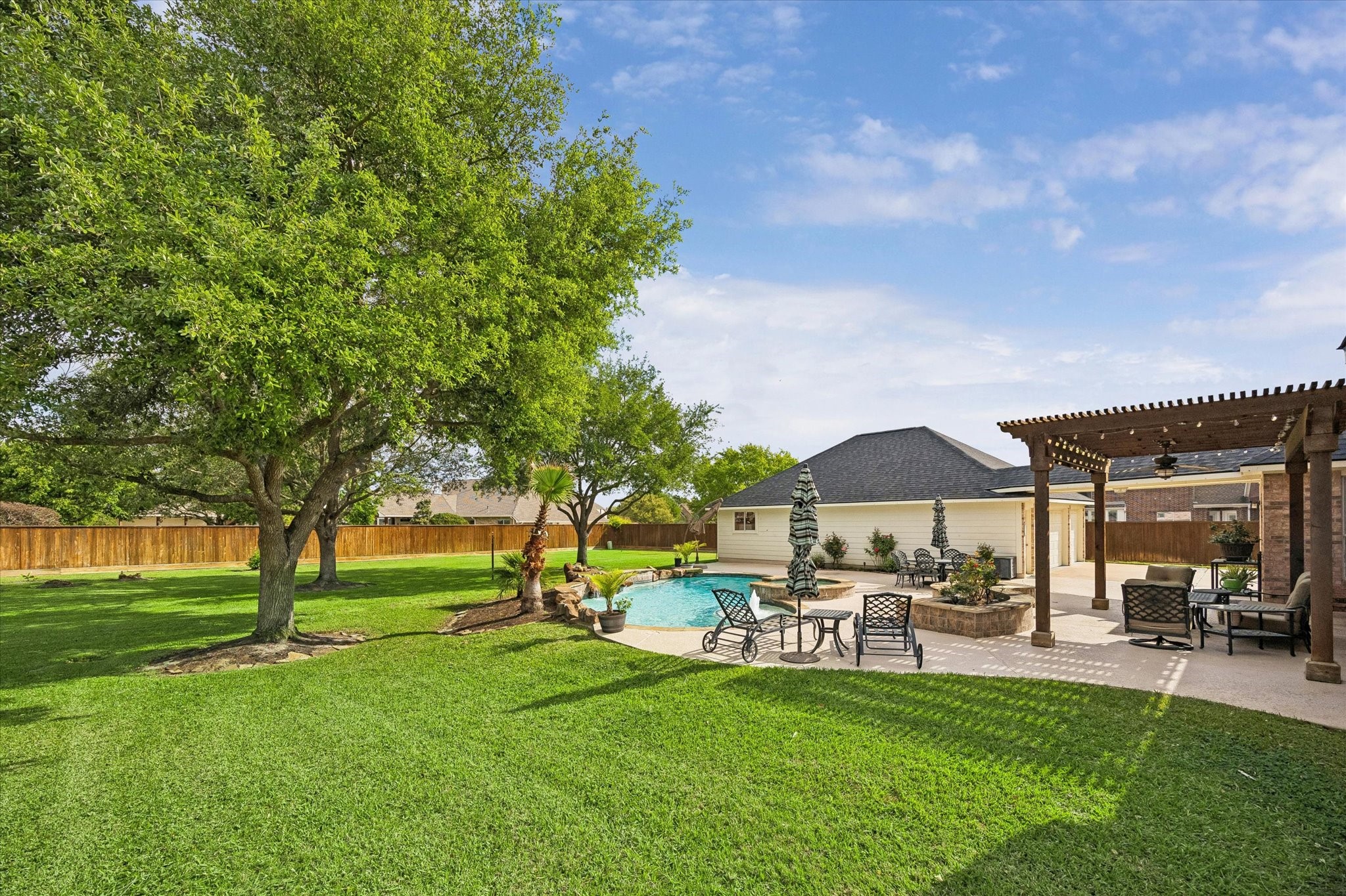20810 East Cameron Ridge Drive Cypress, TX 77433 - Photo 7 of 48 a patio with a table and chairs under an umbrella