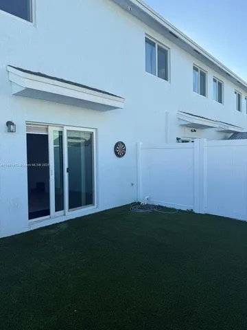 a front view of a house with a garden and yard