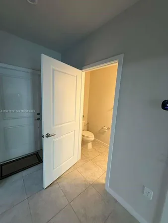 a view of an empty room and a window