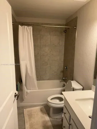 a bathroom with a sink a toilet and a bathtub