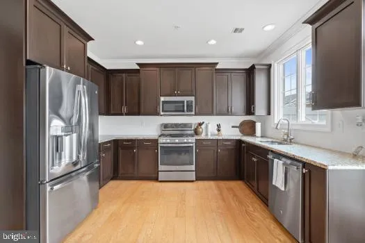 a kitchen with granite countertop stainless steel appliances and wooden cabinets