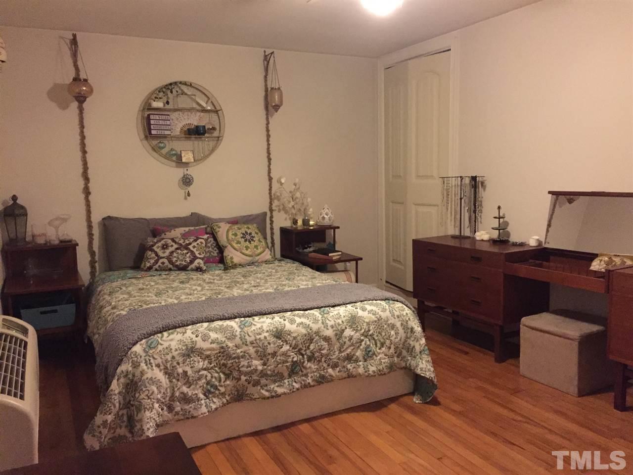 834 Bryan Street, Unit 834 Raleigh, NC 27605 - Photo 11 of 16 a bedroom with bed and wooden floor