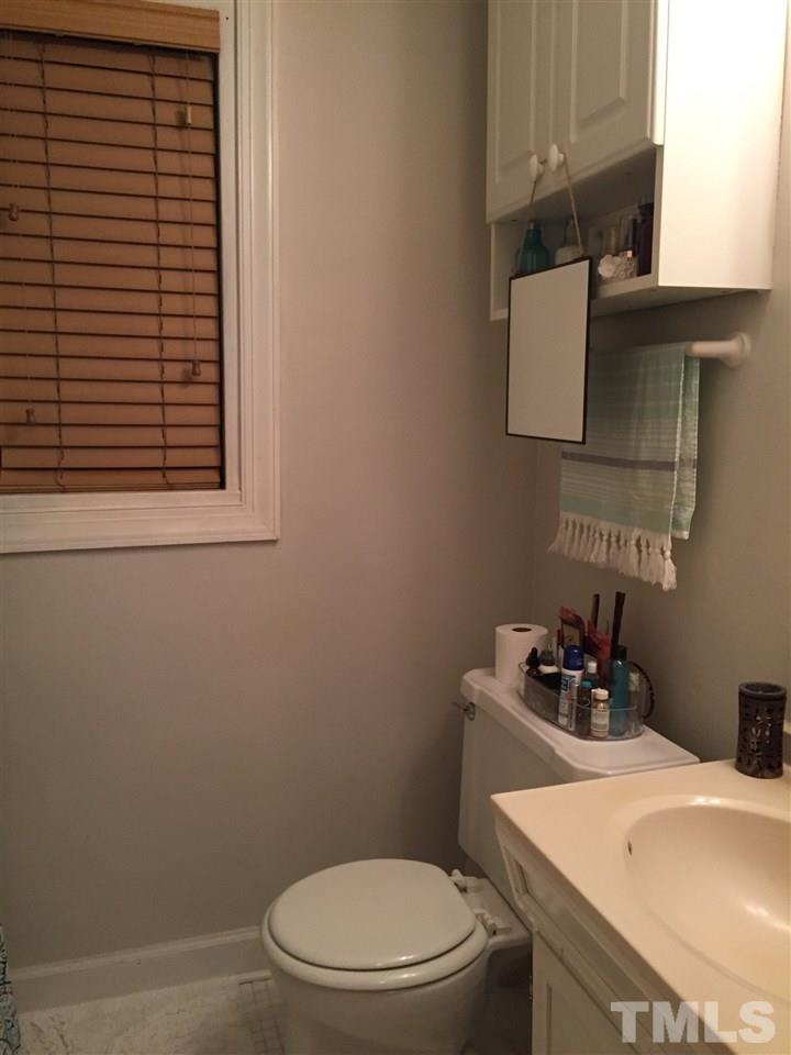 834 Bryan Street, Unit 834 Raleigh, NC 27605 - Photo 14 of 16 a bathroom with a toilet sink and mirror