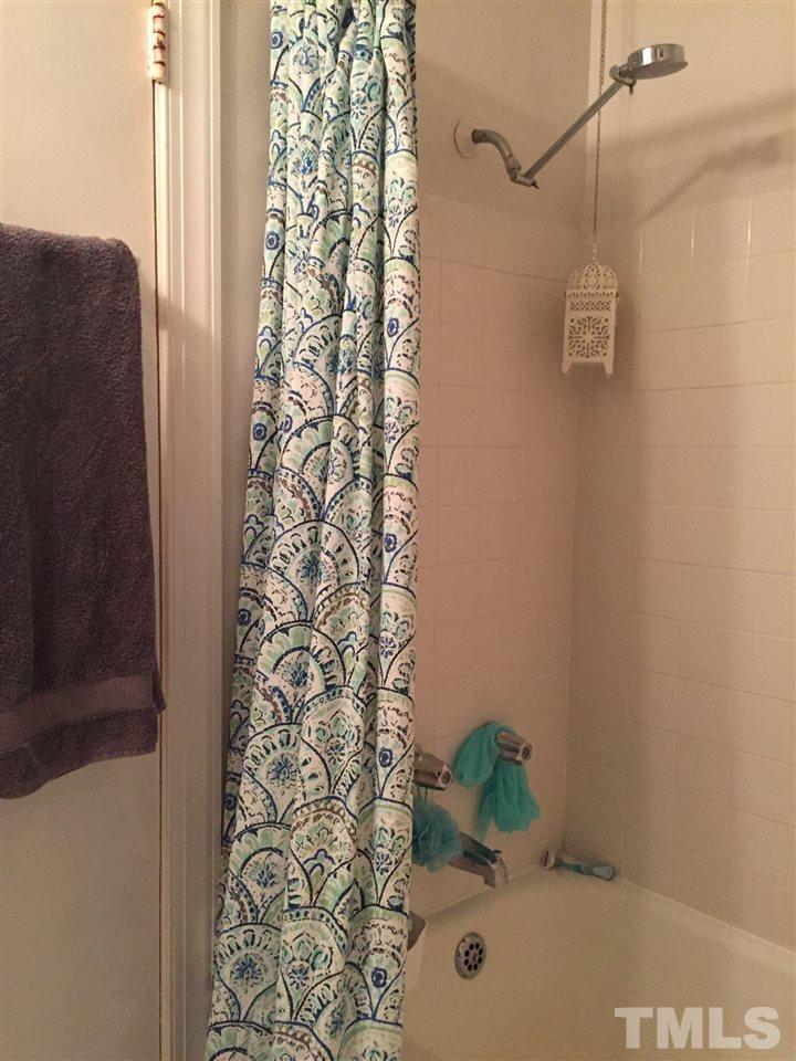 834 Bryan Street, Unit 834 Raleigh, NC 27605 - Photo 15 of 16 a bathroom with a shower curtain and a shower curtain