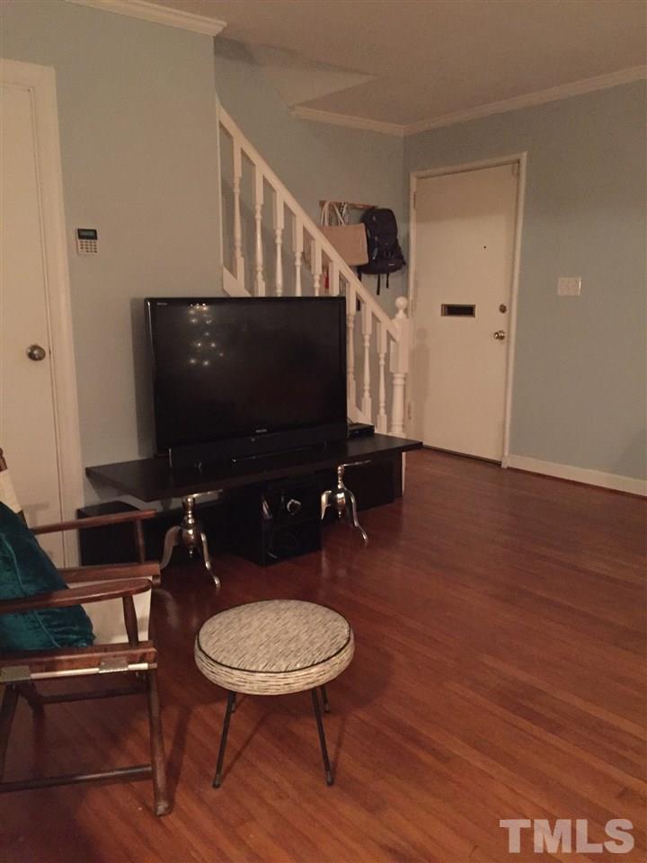 834 Bryan Street, Unit 834 Raleigh, NC 27605 - Photo 5 of 16 a room with furniture and a flat screen tv