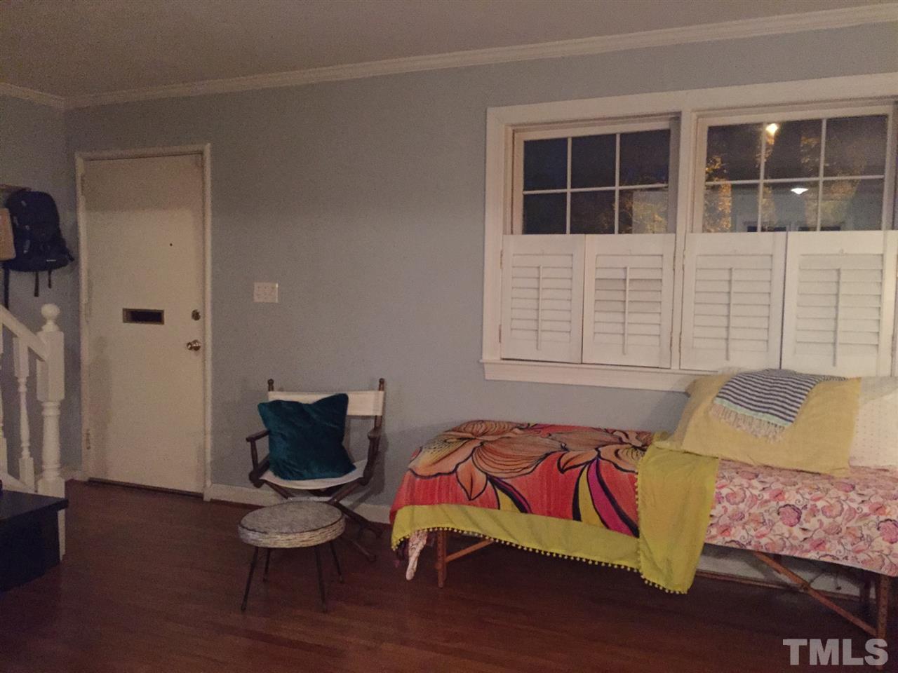 834 Bryan Street, Unit 834 Raleigh, NC 27605 - Photo 6 of 16 a bedroom with a bed and wooden floor
