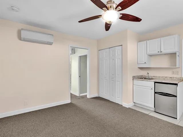 a kitchen with white cabinets and white appliances