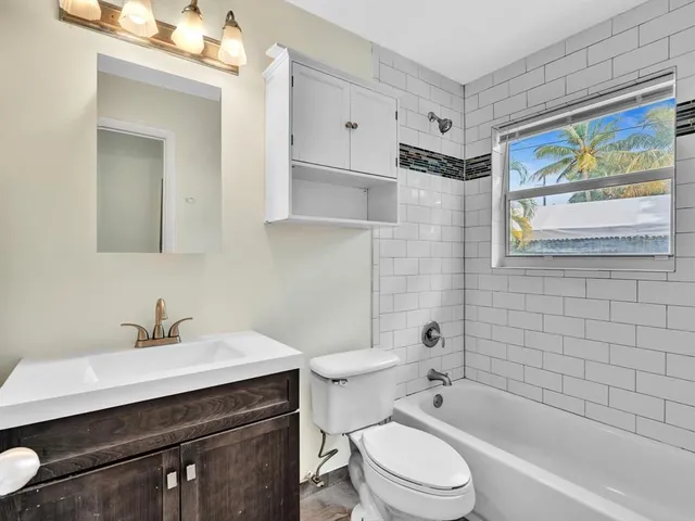 a bathroom with a sink mirror toilet and bathtub