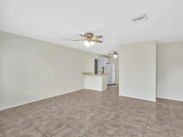 a view of a big room with closet and a ceiling fan