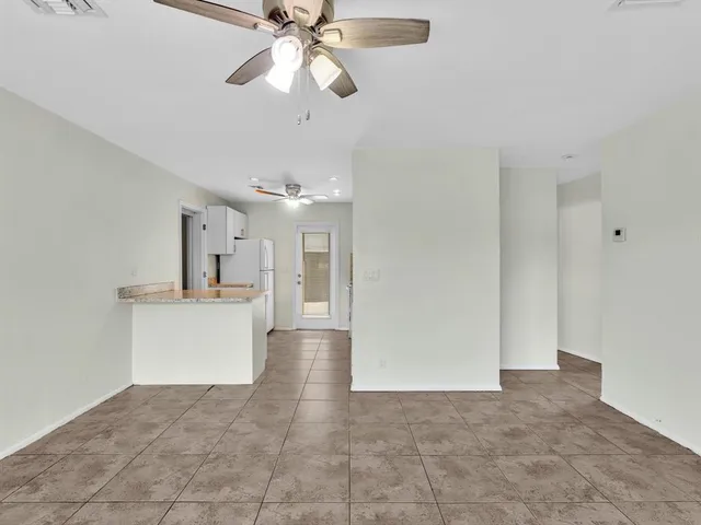 a view of a kitchen with a sink and a chandelier fan