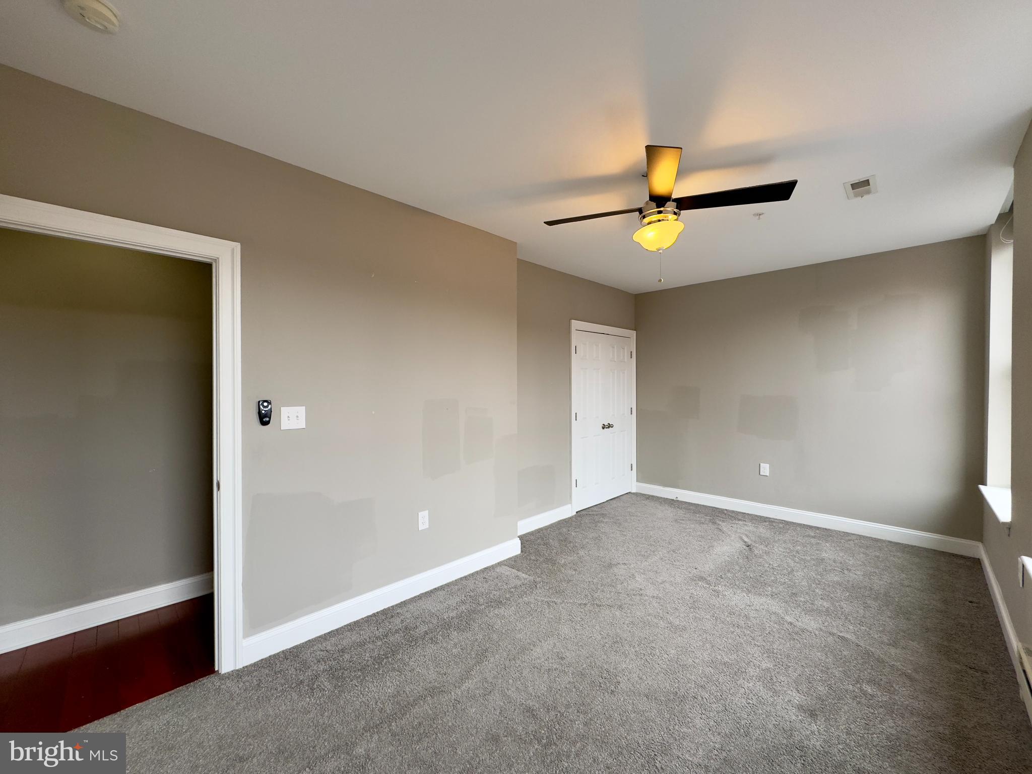 803 Cathedral Street, Unit 8 Baltimore, MD 21201 - Photo 11 of 16 wooden floor in an empty room with a window