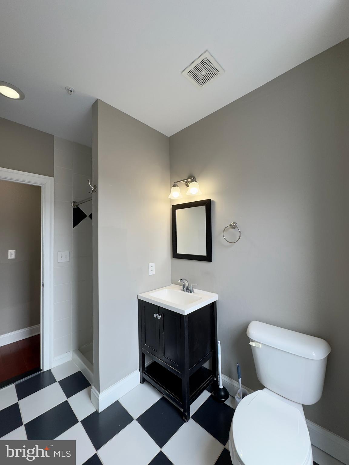 803 Cathedral Street, Unit 8 Baltimore, MD 21201 - Photo 14 of 16 a bathroom with a sink toilet and a mirror