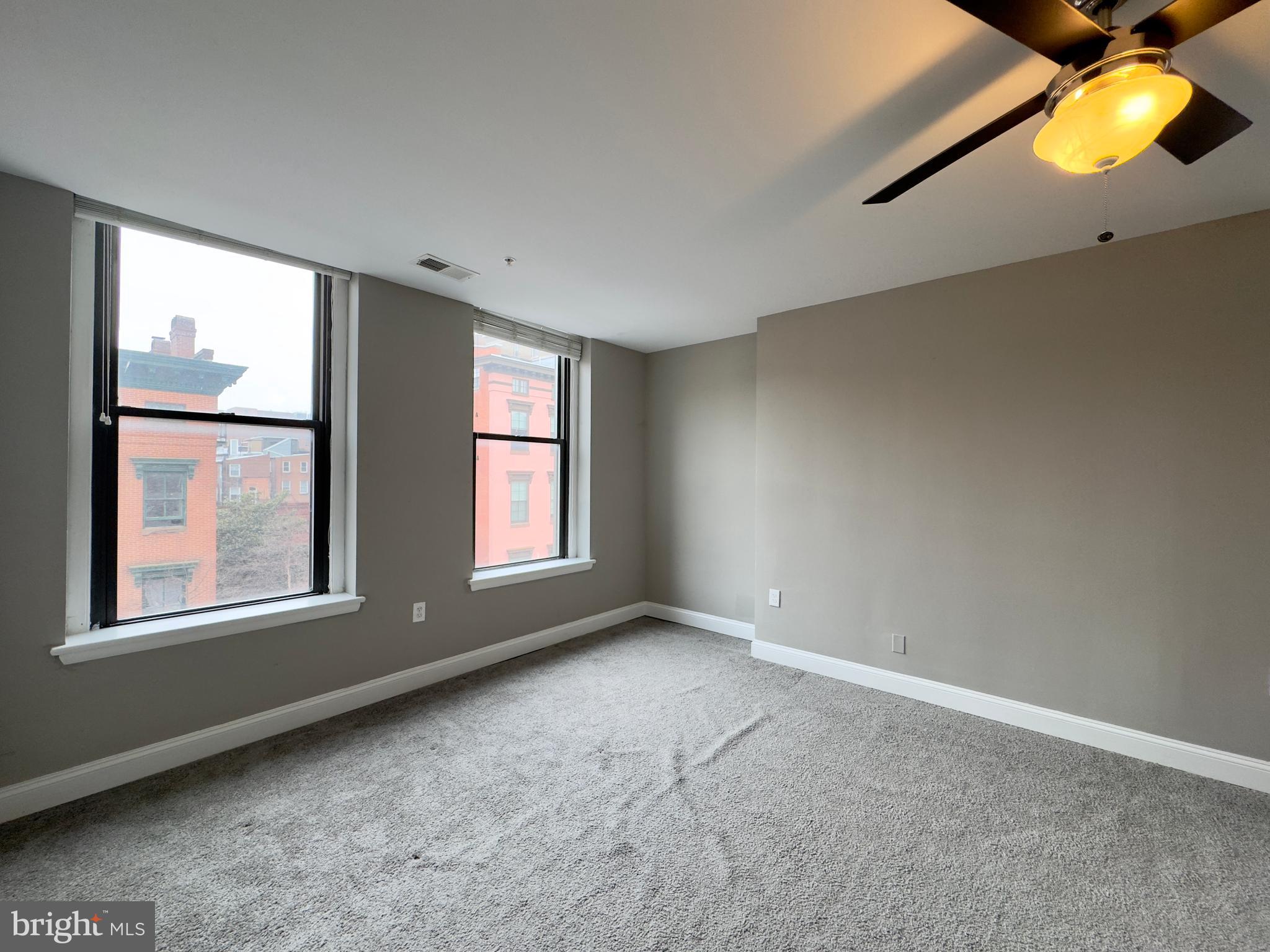 803 Cathedral Street, Unit 8 Baltimore, MD 21201 - Photo 15 of 16 an empty room with windows