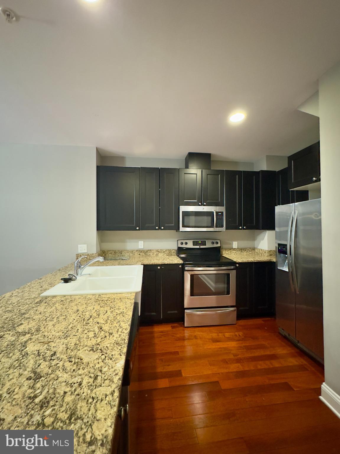 803 Cathedral Street, Unit 8 Baltimore, MD 21201 - Photo 3 of 16 a large kitchen with a stove and refrigerator