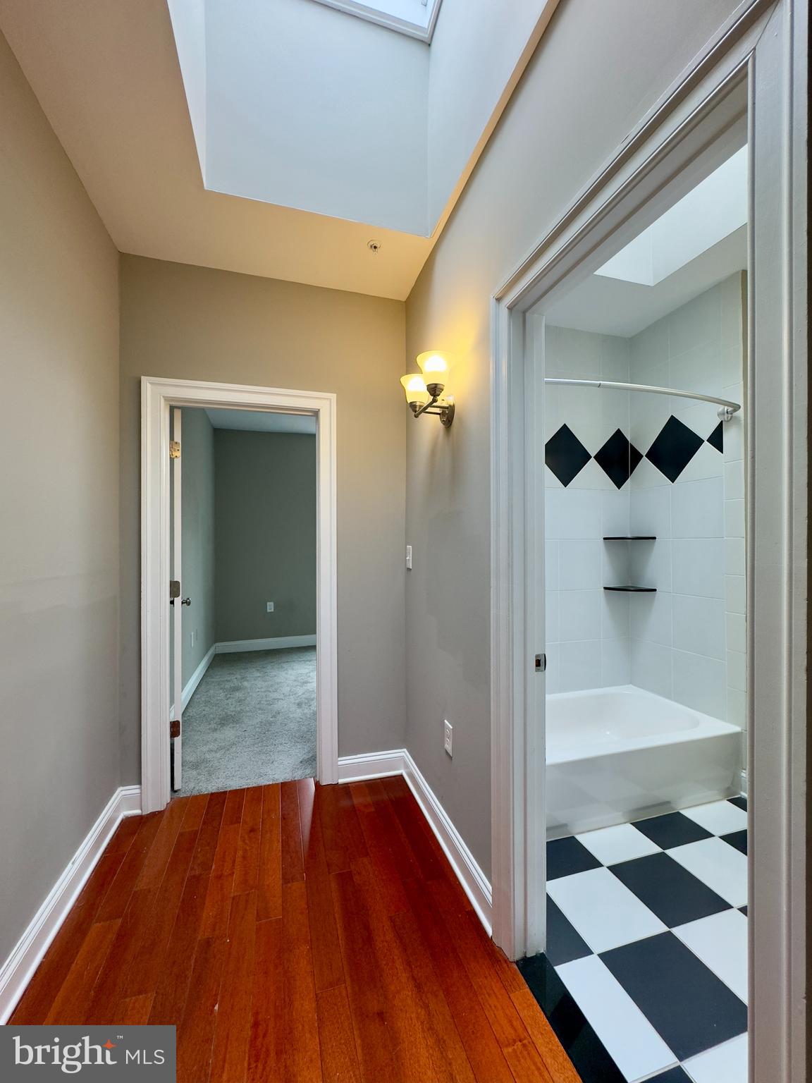 803 Cathedral Street, Unit 8 Baltimore, MD 21201 - Photo 5 of 16 a view of a hallway with wooden floor and a cabinet