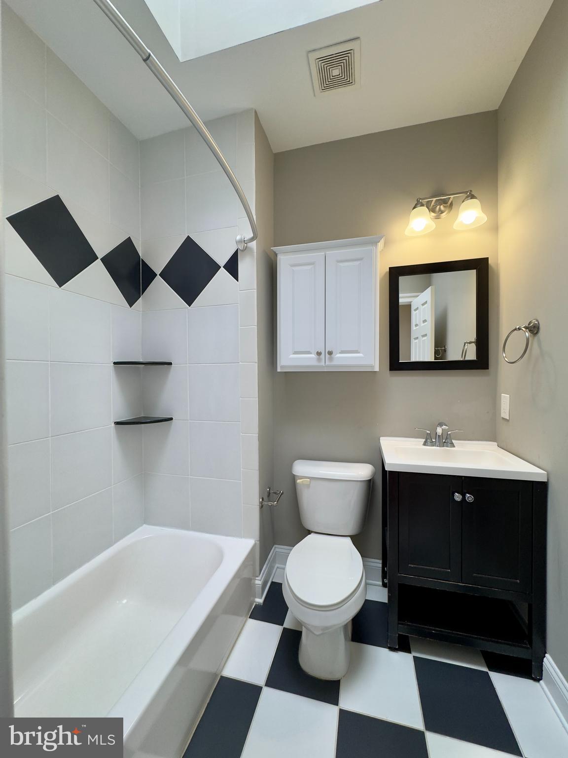 803 Cathedral Street, Unit 8 Baltimore, MD 21201 - Photo 6 of 16 a bathroom with a sink a toilet and mirror