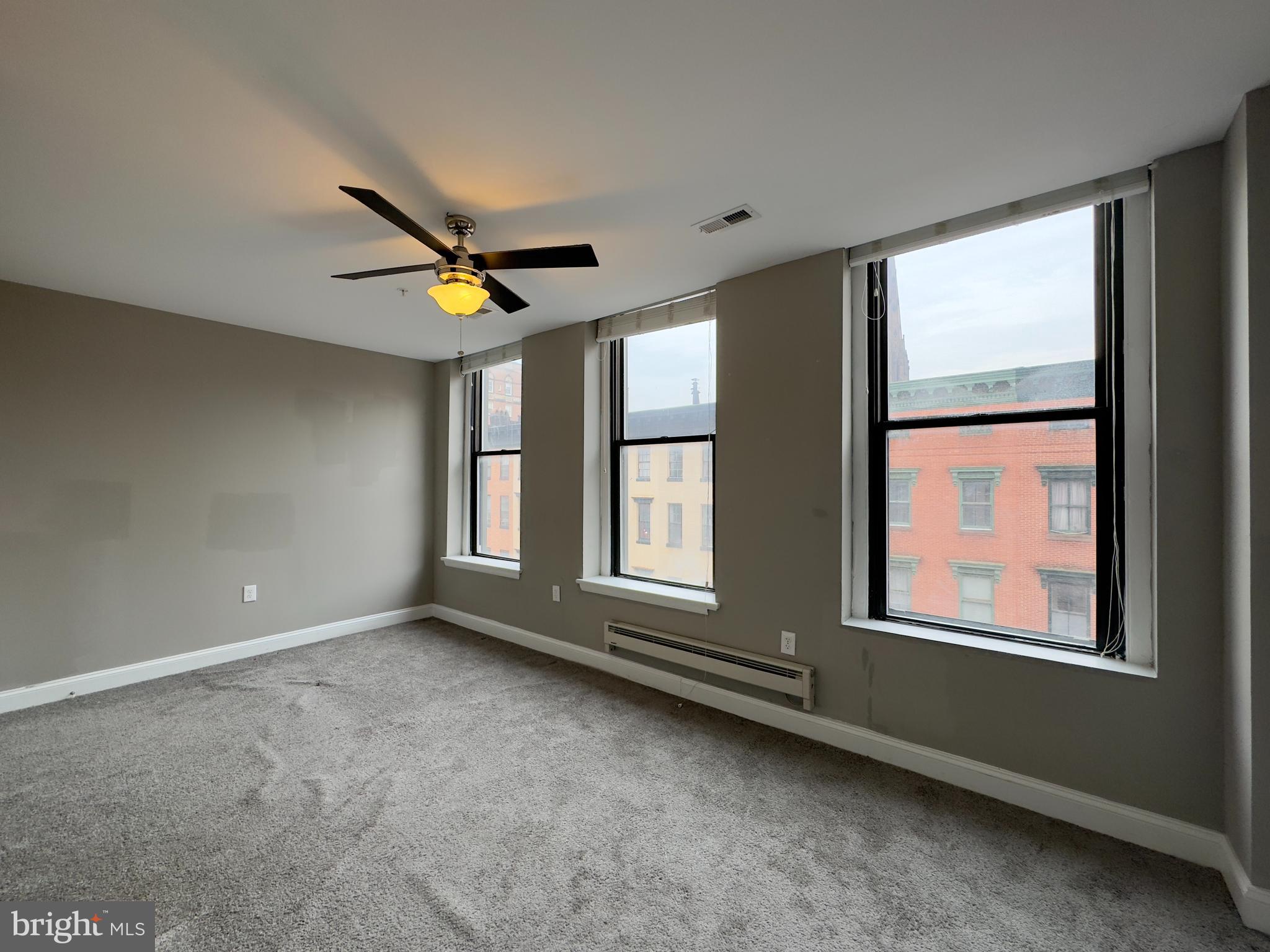 803 Cathedral Street, Unit 8 Baltimore, MD 21201 - Photo 10 of 16 a view of an empty room with a window