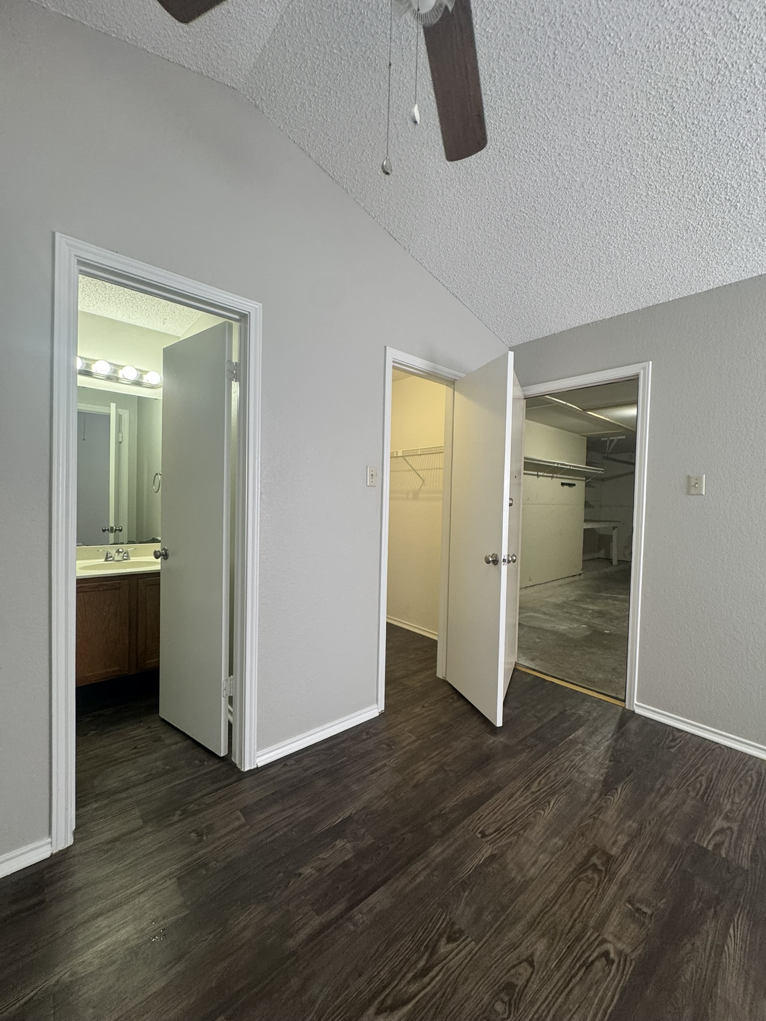 522 Cutty Trail, Unit B Lakeway, TX 78734 - Photo 16 of 20 Step into a comfortable bedroom featuring durable wood flooring and an integrated ceiling fan.