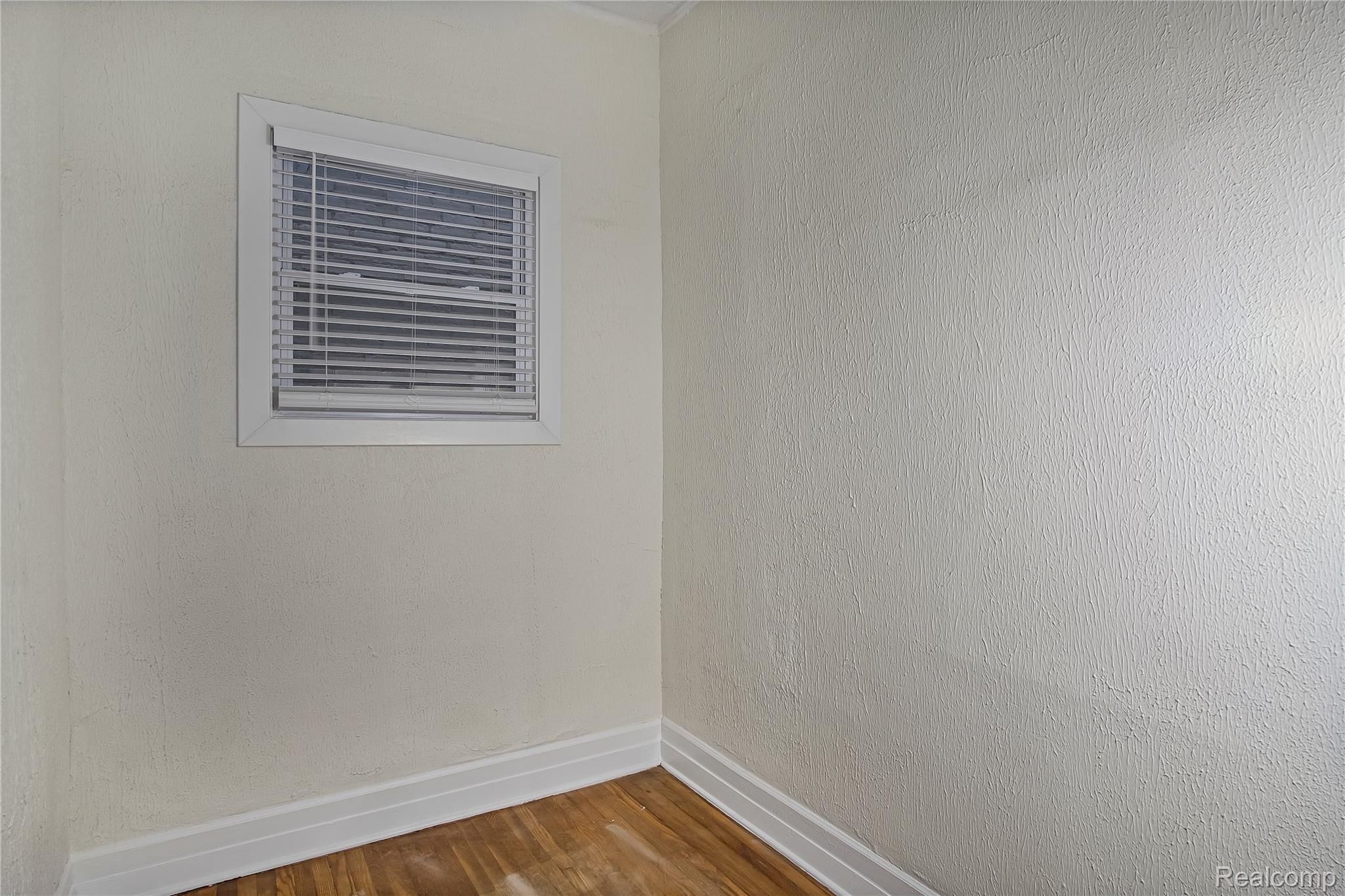 427 Melbourne Street Detroit, MI 48202 - Photo 18 of 29 Unfurnished room featuring baseboards and wood finished floors