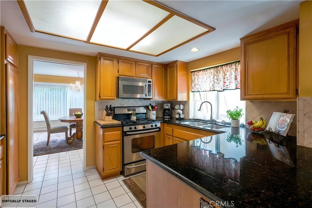 24422 Cielo Laguna Niguel, CA 92677 - Photo 9 of 23 a kitchen with granite countertop a sink a counter top space appliances and cabinets