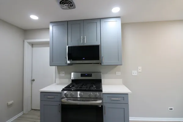 a kitchen with a stove and a microwave