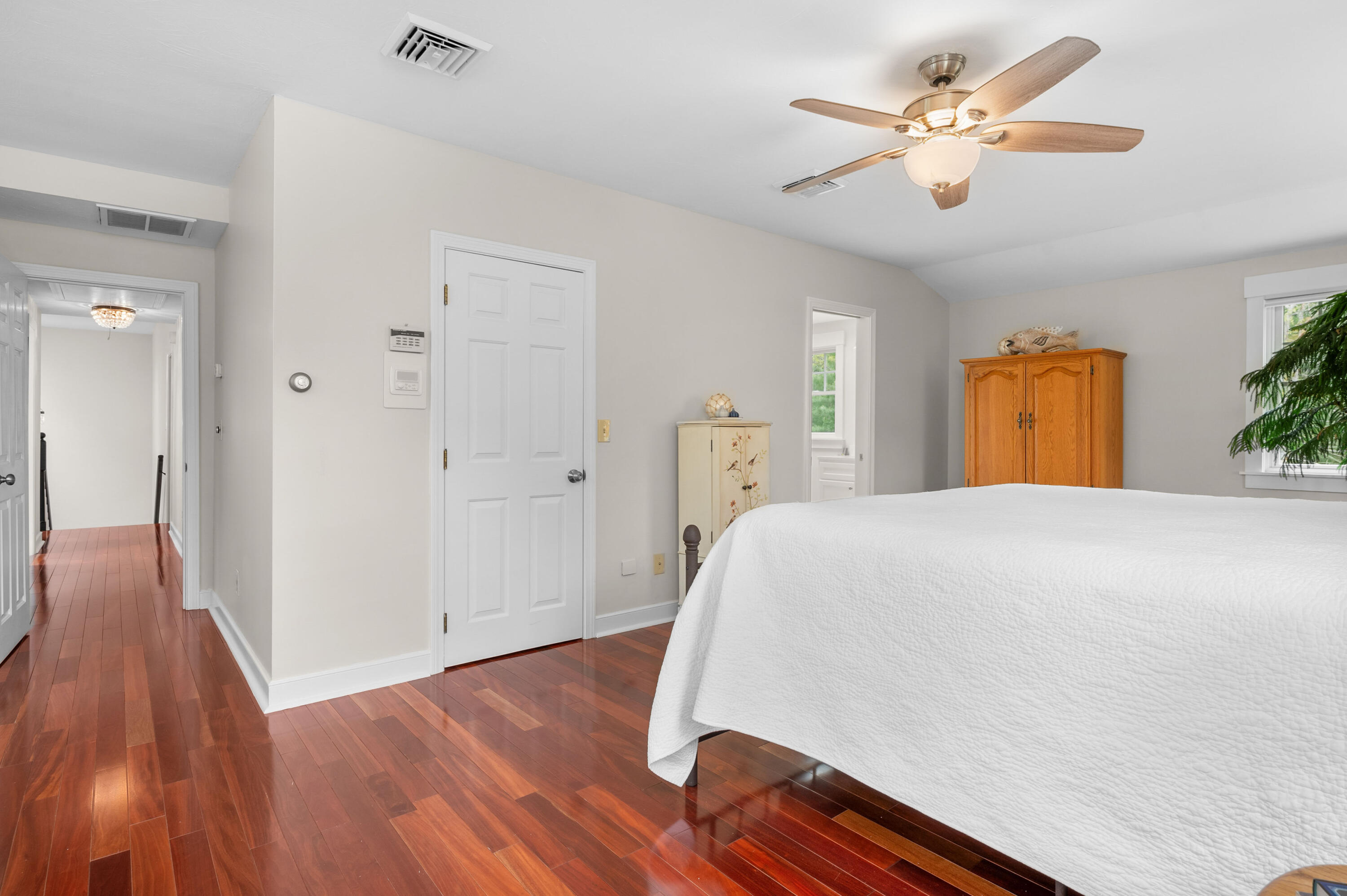 50 Hyde Park Centerville, MA 02632 - Photo 23 of 38 a bedroom with a bed and a chandelier