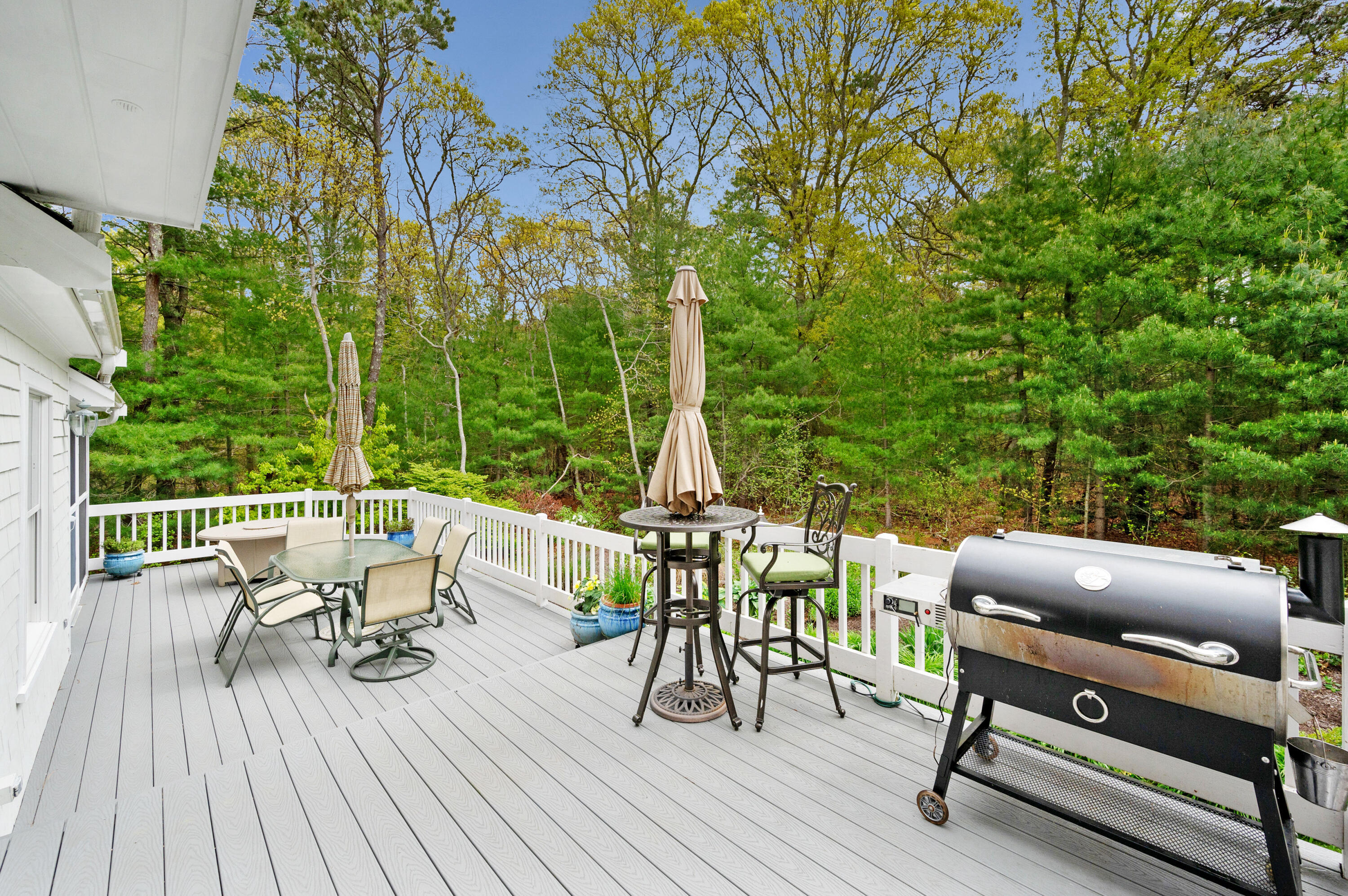 50 Hyde Park Centerville, MA 02632 - Photo 30 of 38 a view of a patio with couches table and chairs and wooden floor