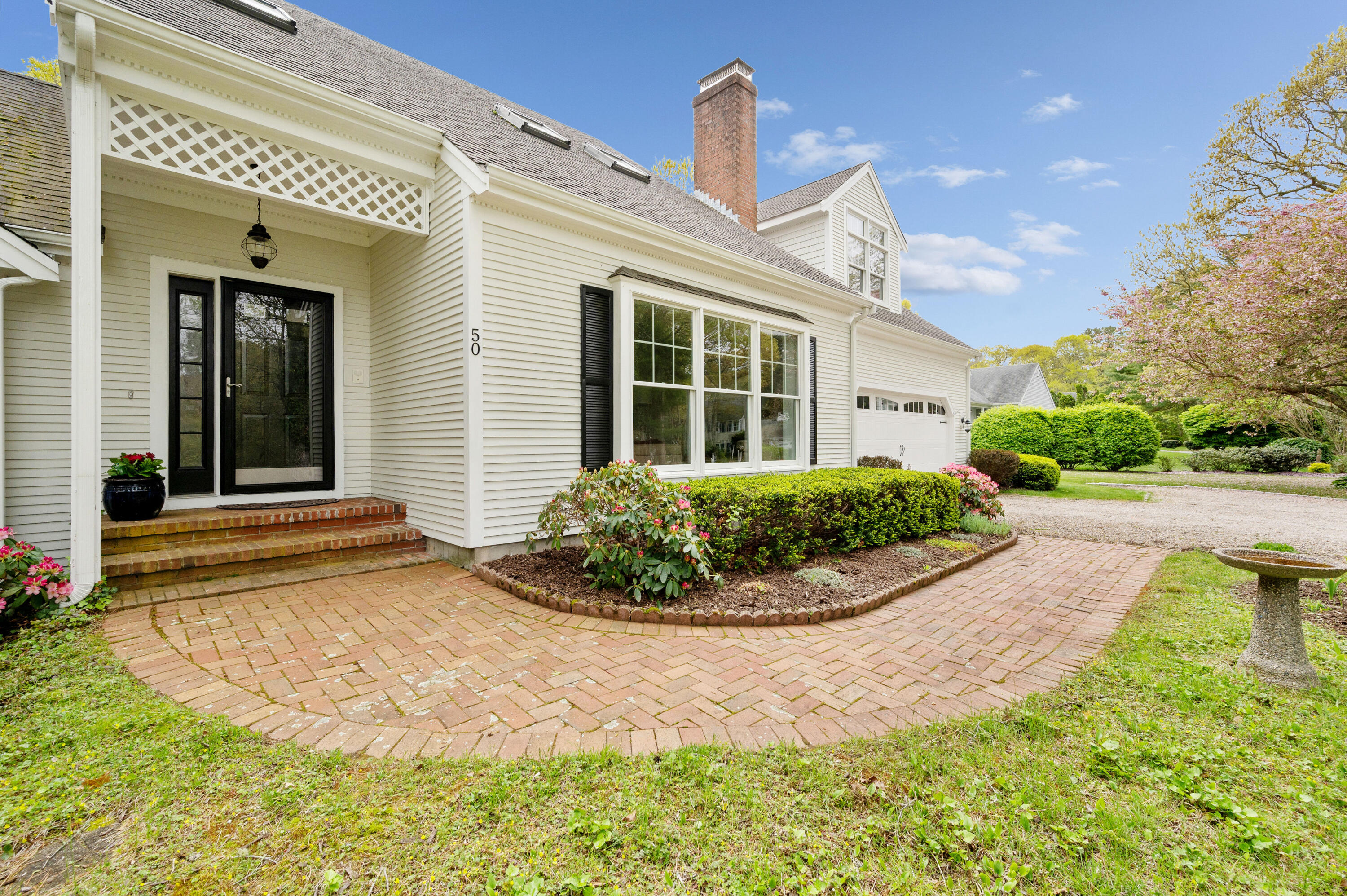 50 Hyde Park Centerville, MA 02632 - Photo 3 of 38 a view of a white house with a small yard plants and large tree