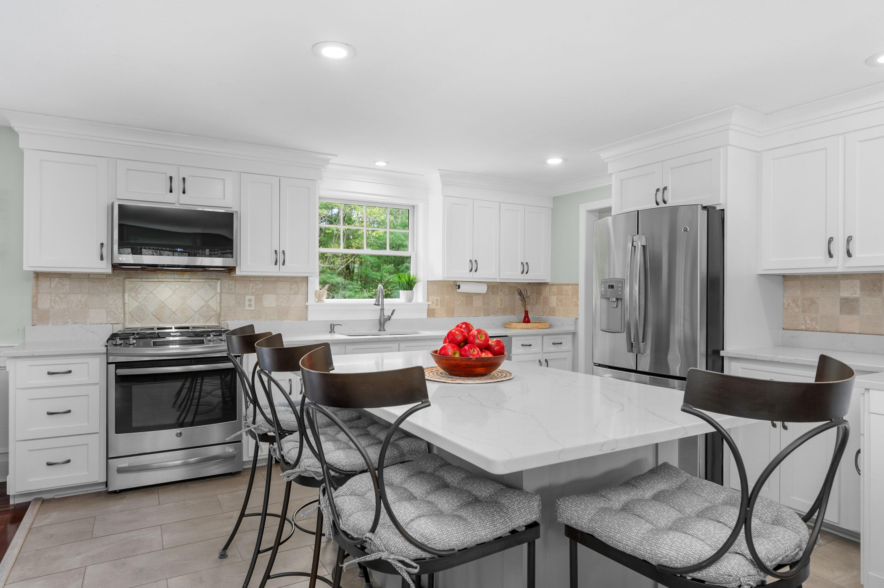 50 Hyde Park Centerville, MA 02632 - Photo 6 of 38 a kitchen with stainless steel appliances a stove a sink a microwave a refrigerator and cabinets