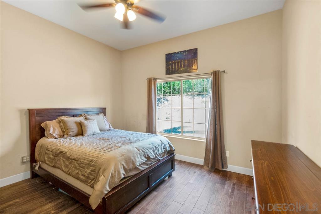 3022 Camino Del Rancho Encinitas, CA 92024 - Photo 13 of 18 a bedroom with a bed and a chair