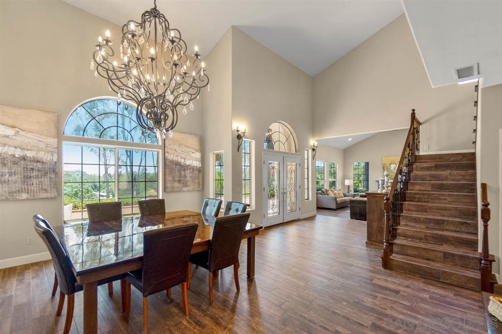 3022 Camino Del Rancho Encinitas, CA 92024 - Photo 5 of 18 a view of a dining room with furniture wooden floor and chandelier