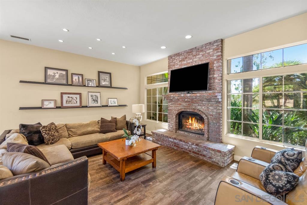 3022 Camino Del Rancho Encinitas, CA 92024 - Photo 6 of 18 a living room with furniture fireplace and flat screen tv