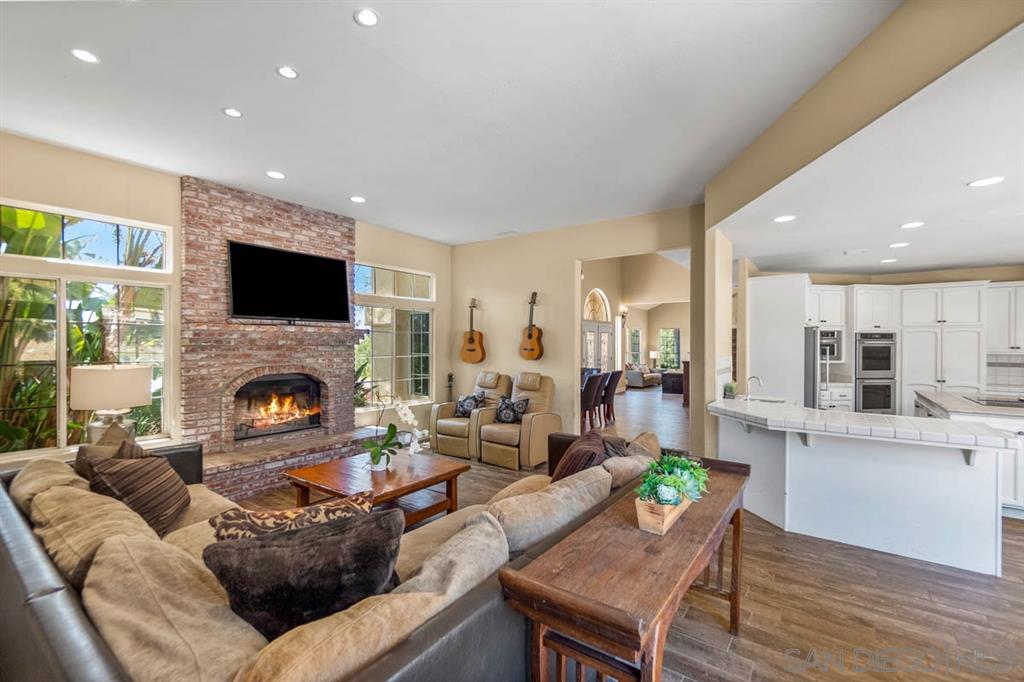 3022 Camino Del Rancho Encinitas, CA 92024 - Photo 7 of 18 a living room with furniture a flat screen tv and a fireplace