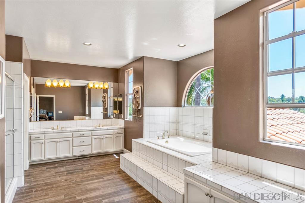 3022 Camino Del Rancho Encinitas, CA 92024 - Photo 10 of 18 a bathroom with a double vanity sink and a bathtub