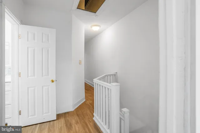 a view of a hallway with wooden floor